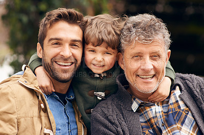 Buy stock photo Shot of a grandfather, his adult son and grandson enjoying a day outdoors