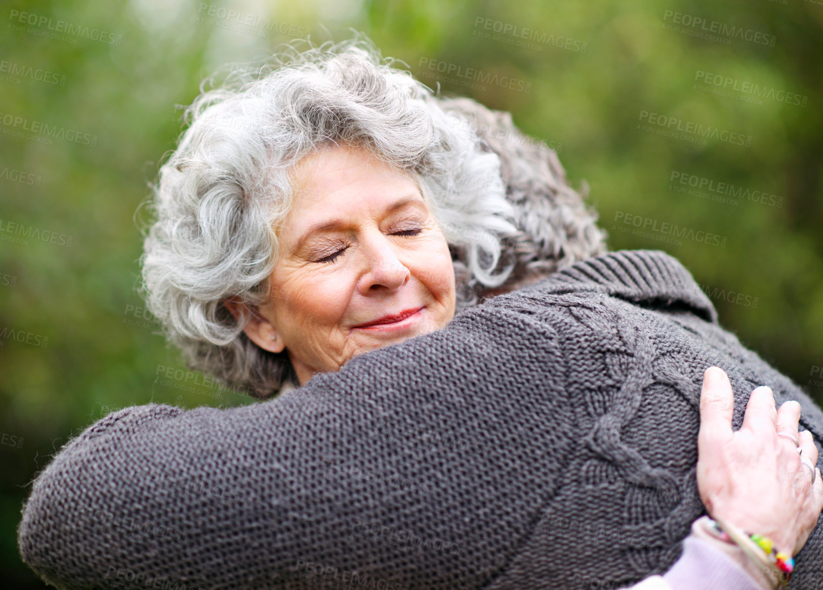 Buy stock photo Shot of a senior woman lovingly embracing her husband