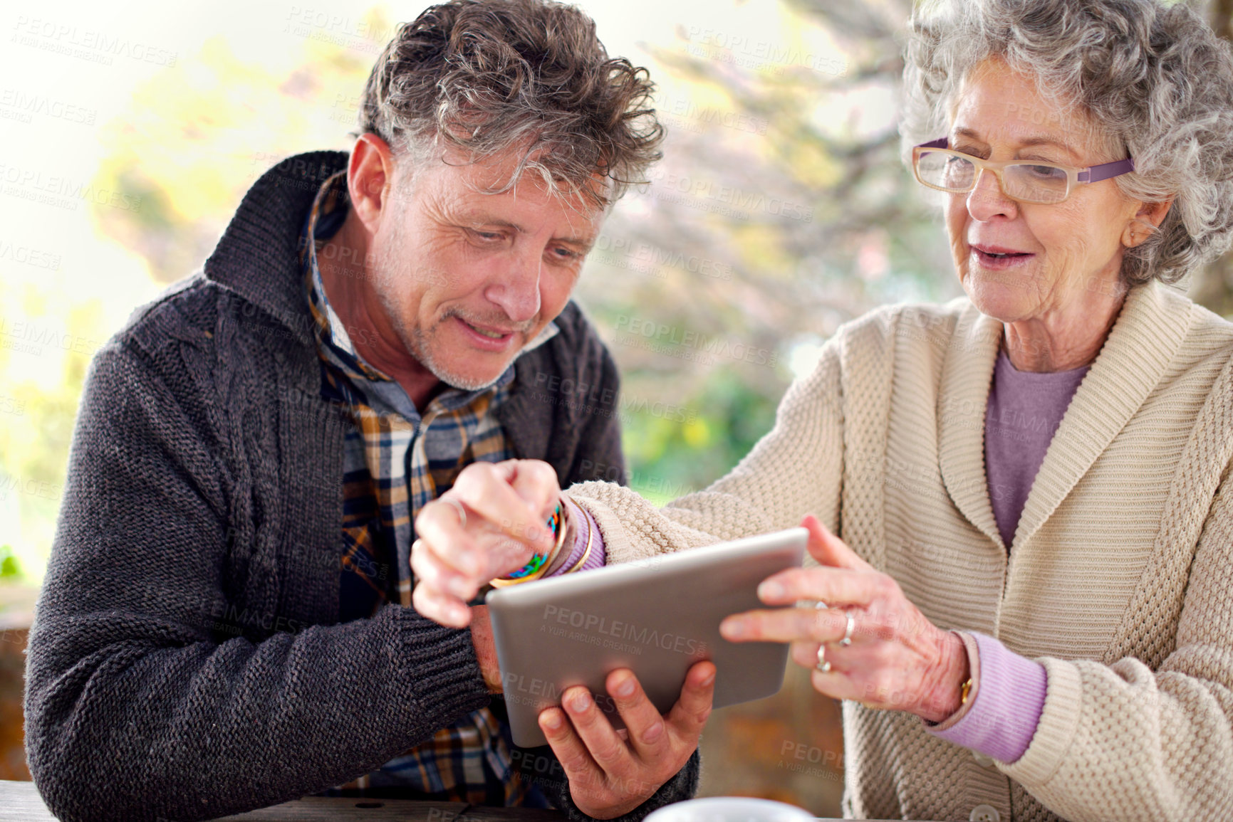 Buy stock photo Senior couple, tablet or communication to relax on social media, website or bonding together. Older married people, touch screen or happy to search for ebook, news or email for streaming app