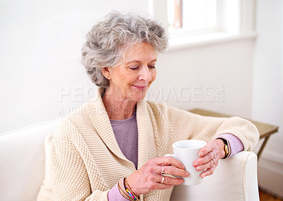Buy stock photo Coffee, sofa and elderly woman in living room for morning enjoyment, weekend and retirement. Relax, smile and senior female person with happiness for warm drink, beverage and satisfaction at home