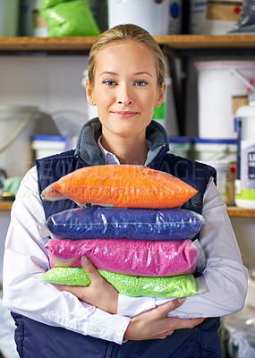 Buy stock photo Woman, bag and plastic in factory, pellets and dye manufacturing and ecology in portrait at store. Person, color and employee for recycling at plant with storage, particles and polymer in warehouse