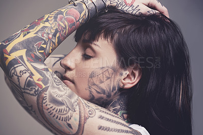 Buy stock photo Tattoo, culture and rebel with woman, punk rock and tradition on a grey studio background. Profile, person and model with ideas and creativity with cool gothic art with ink, trendy and edgy design
