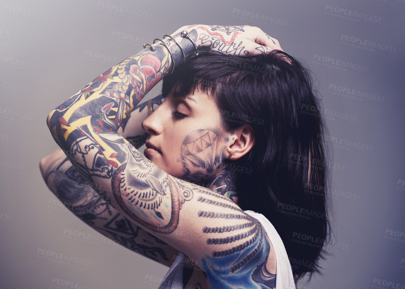 Buy stock photo Tattoo, edgy design and rebel with woman, punk rock and tradition on a grey studio background. Profile, person and model with ideas or creative with emo and gothic art with ink, trendy or heavy metal