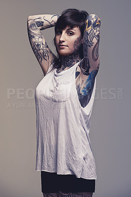 Buy stock photo Portrait, tattoo and punk rock with woman, rebel and creativity on a grey studio background. Heavy metal, artistic or model with confidence or proud with edgy person or trendy with ink or casual girl