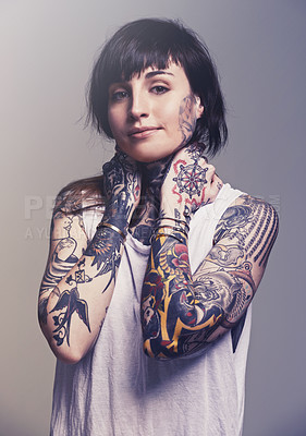 Buy stock photo A cropped studio portrait of a tattooed young woman
