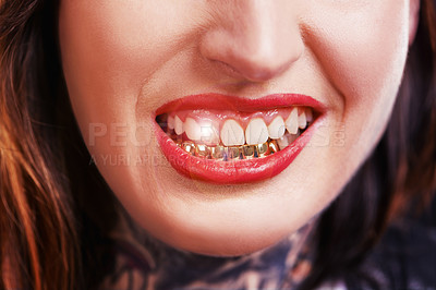 Buy stock photo Woman, mouth and smile with gold teeth to shine for glamour and wealth with cosmetics. Closeup, dental jewelry and custom grill for fashion as female person with confidence, style and satisfied.