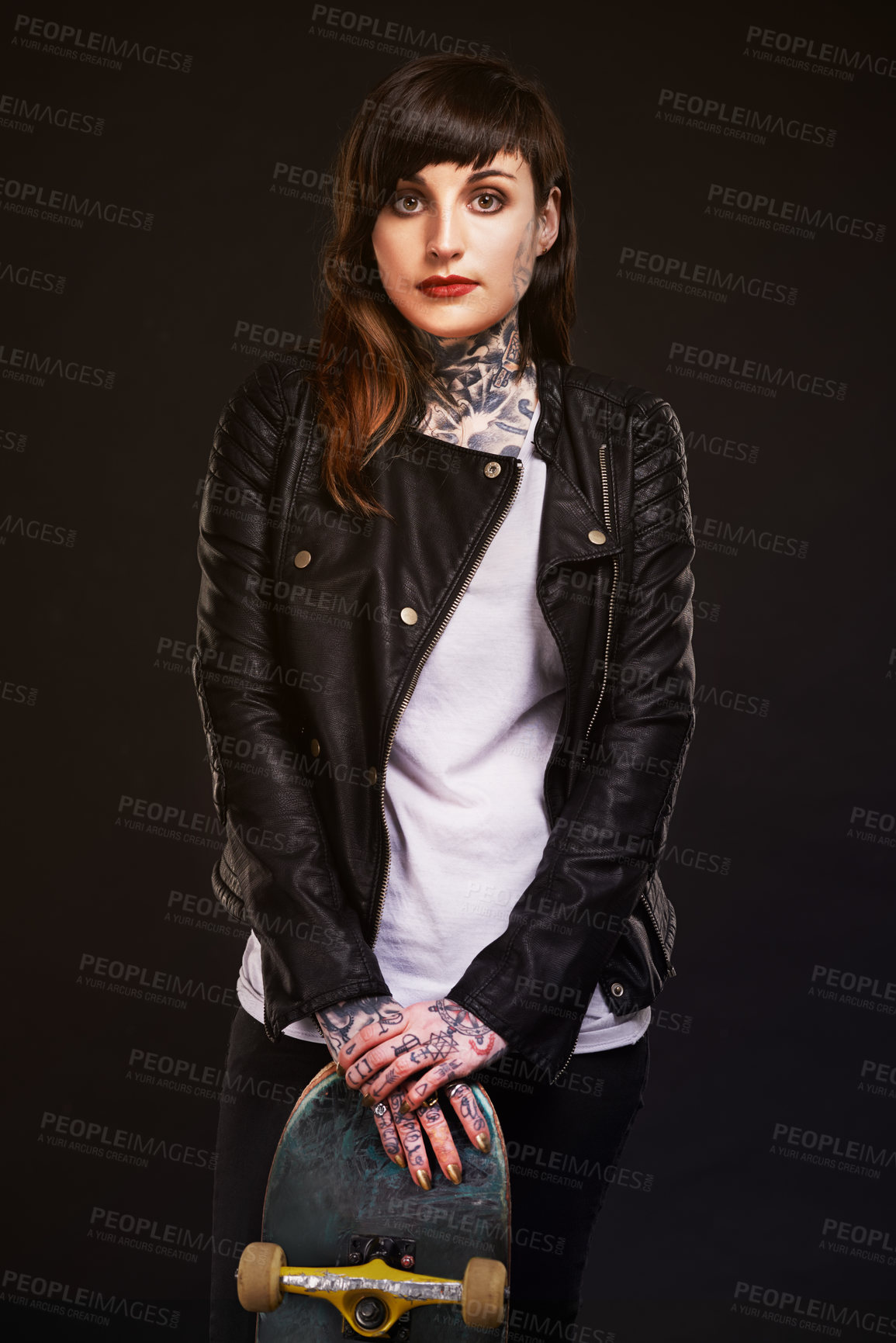 Buy stock photo Studio shot of a young skater covered in tattoos