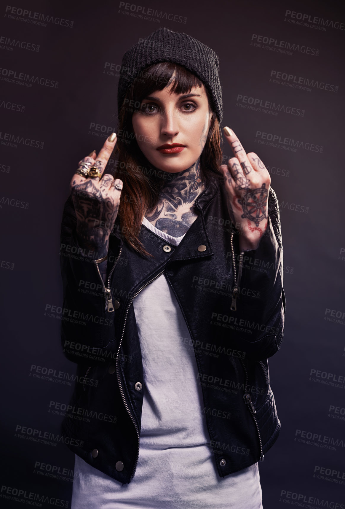 Buy stock photo Portrait, fashion woman with middle finger, tattoo or attitude in studio with gothic, style or artistic expression on black background. Rebel, face and emo model with hand, emoji or grunge aesthetic