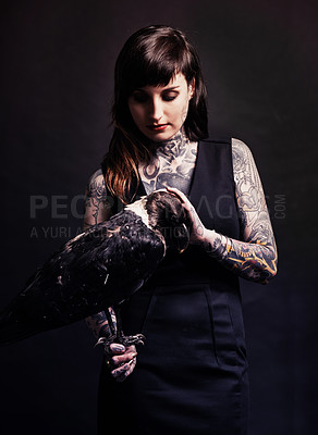 Buy stock photo Fashion, woman and bird animal in studio for witchcraft or magic, mysterious and fantasy with punk culture. Person, eagle and isolated on black background for darkness and creepy grunge look.