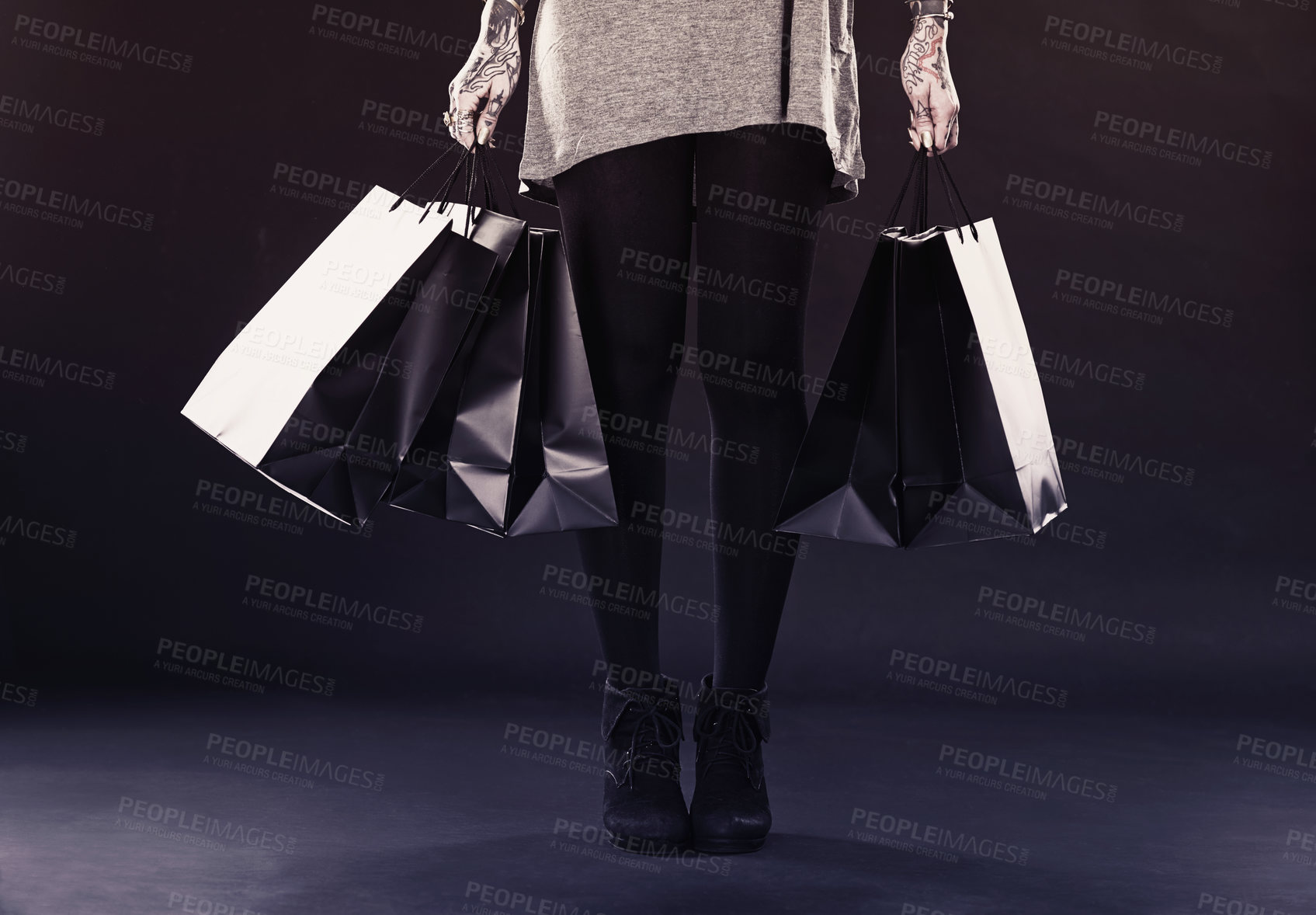 Buy stock photo Woman, legs and shopping bags for fashion in studio on dark background with retail, discount and clothes. Female person, tattoo and edgy style with creative look, body ink and art for self care 