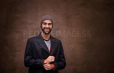 Buy stock photo Man, portrait and smile with urban, fashion and trendy gentleman jacket. Model, winter and beanie with city, happiness and outdoor positivity for cool hipster style isolated on brown wall background