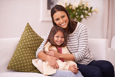 Buy stock photo Portrait of a mother and daughter sitting together on a sofa