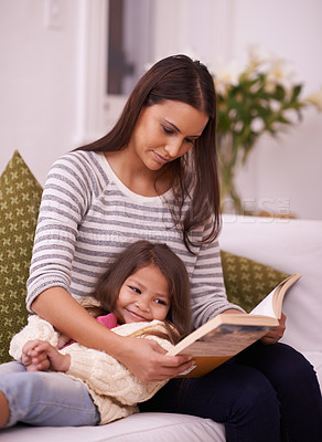 Buy stock photo Woman, girl child or book on sofa as reading, imagine or fiction of happy bonding together in home. Mother, daughter or stories to relax on couch as listen or idea of fairy tale novel at weekend