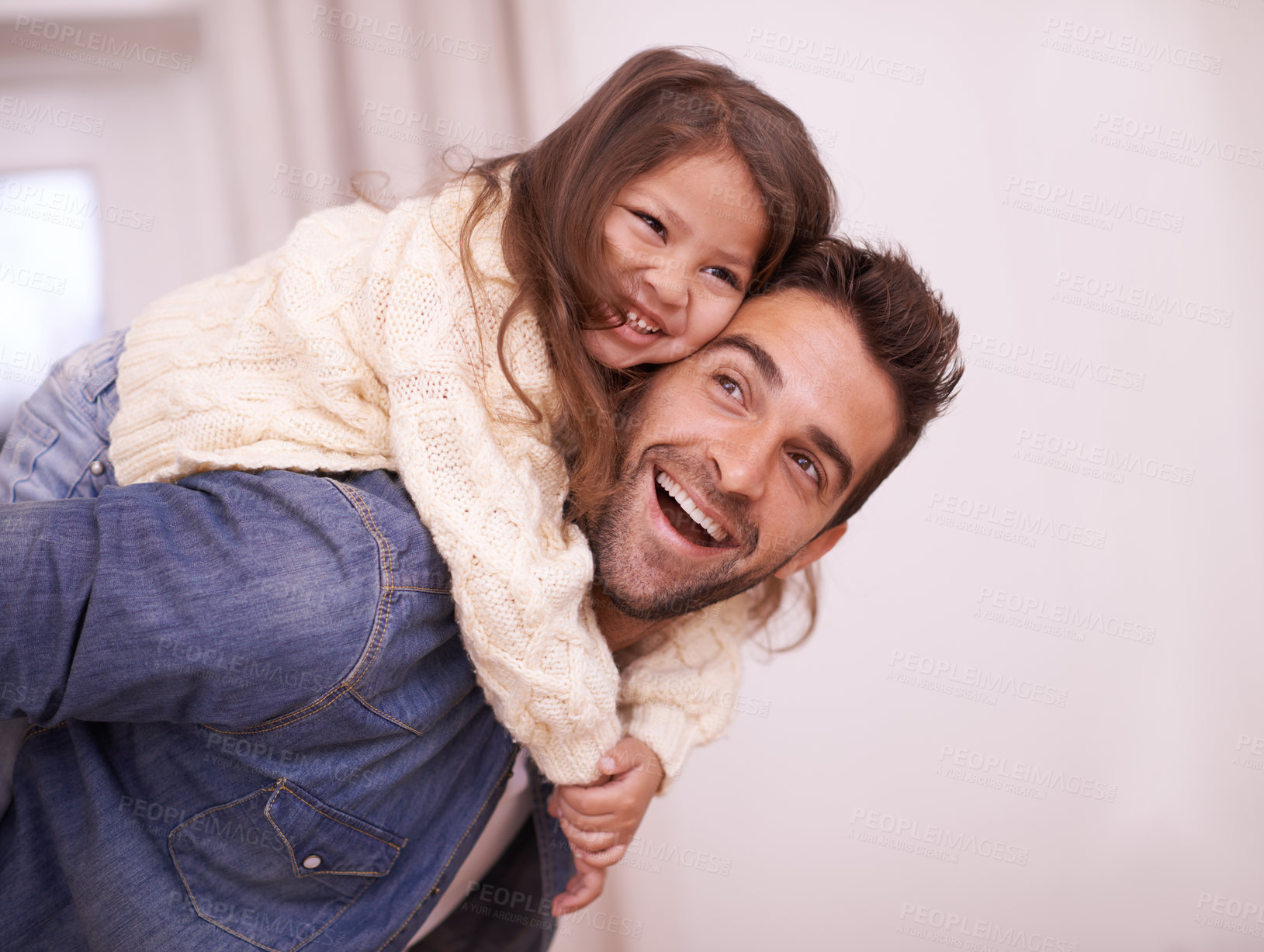 Buy stock photo Shot of a father giving his daughter a piggyback ride at home