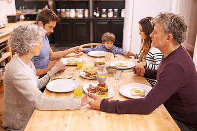 Buy stock photo Cropped shot of a family saying grace before eating breakfast