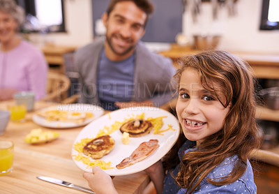 Buy stock photo Portrait, child and breakfast in kitchen in home with family, eating and bonding together at table. Food, pancakes and father or grandmother with waffle for brunch nutrition or communication at house