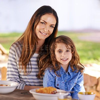 Buy stock photo Mother and girl in portrait at table with breakfast for nutrition, together, healthy and natural. Woman with daughter and happy with family at morning outdoors with bonding, smiling and hungry