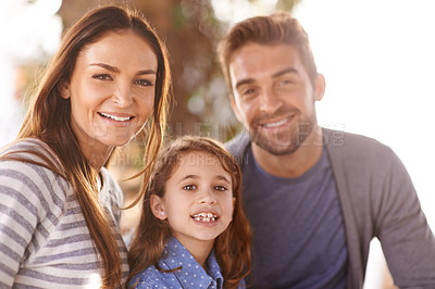 Buy stock photo Happy family, portrait and smile in park by trees, sunshine and outdoor on vacation, bonding and relax. Father, mother and daughter in nature for summer, together and holiday with connection for love