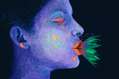 Buy stock photo Shot of a young  woman posing with neon paint on her face