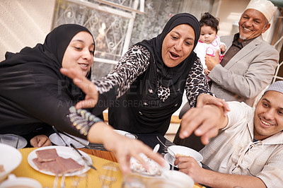 Buy stock photo Muslim family, Eid and excited by table with food for eating, celebration and conversation together. Islamic people, culture and religious event with fight for lunch, nutrition and special holiday