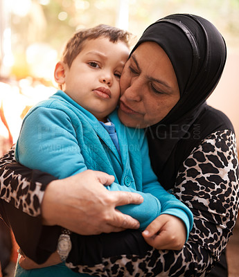 Buy stock photo Muslim woman, hug and grandchild in home in portrait, love and bonding together on holiday. Woman, boy face and happy in embrace in house in islam family and affection in morning in arabic culture