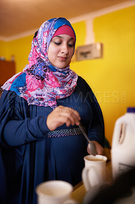 Buy stock photo Muslim woman, mug and making coffee in kitchen for morning enjoyment, warm drink and preparation. Female person, cup and beverage with milk for routine, start day or caffeine satisfaction at home