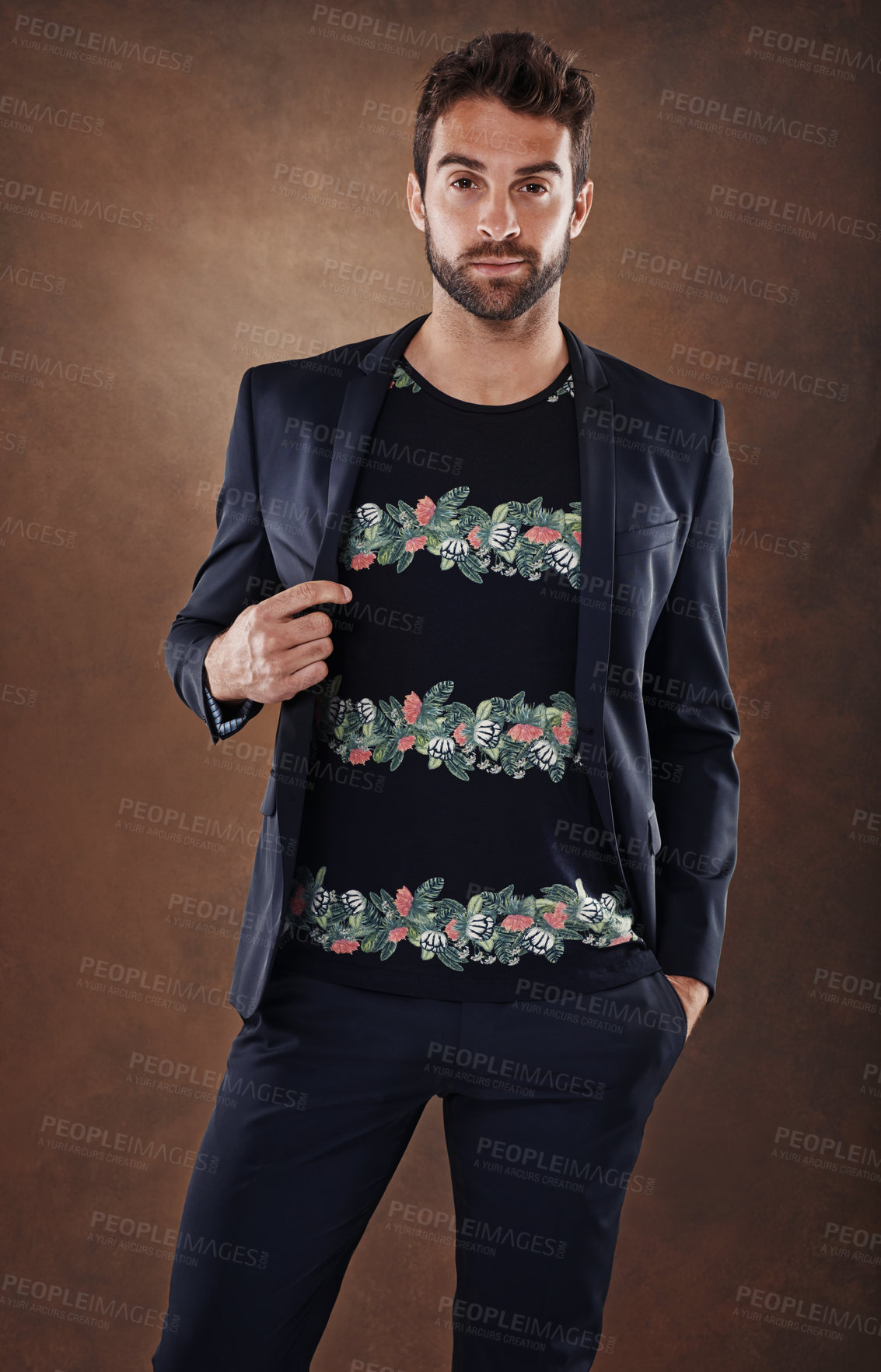 Buy stock photo Spanish male, model and fashion portrait in studio, stylish and isolated on brown background. Clothing, confidence and backdrop space with pose, casual and trendy outfits for cool mens apparel. 