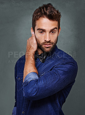 Buy stock photo Fashionable man, model and trendy clothes in studio on grey background for clothing, isolated and confidence with style. Male person, apparel and well dressed on backdrop while touching ear.