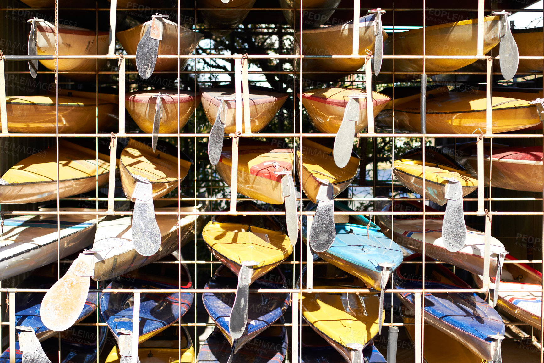 Buy stock photo Shot of a stacked kayaks