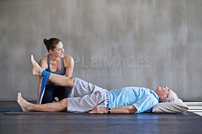 Buy stock photo Therapist, legs and elderly man with resistance band for physical therapy at rehabilitation center. Medical, help and physiotherapist with senior male patient with consultation for injury at clinic.