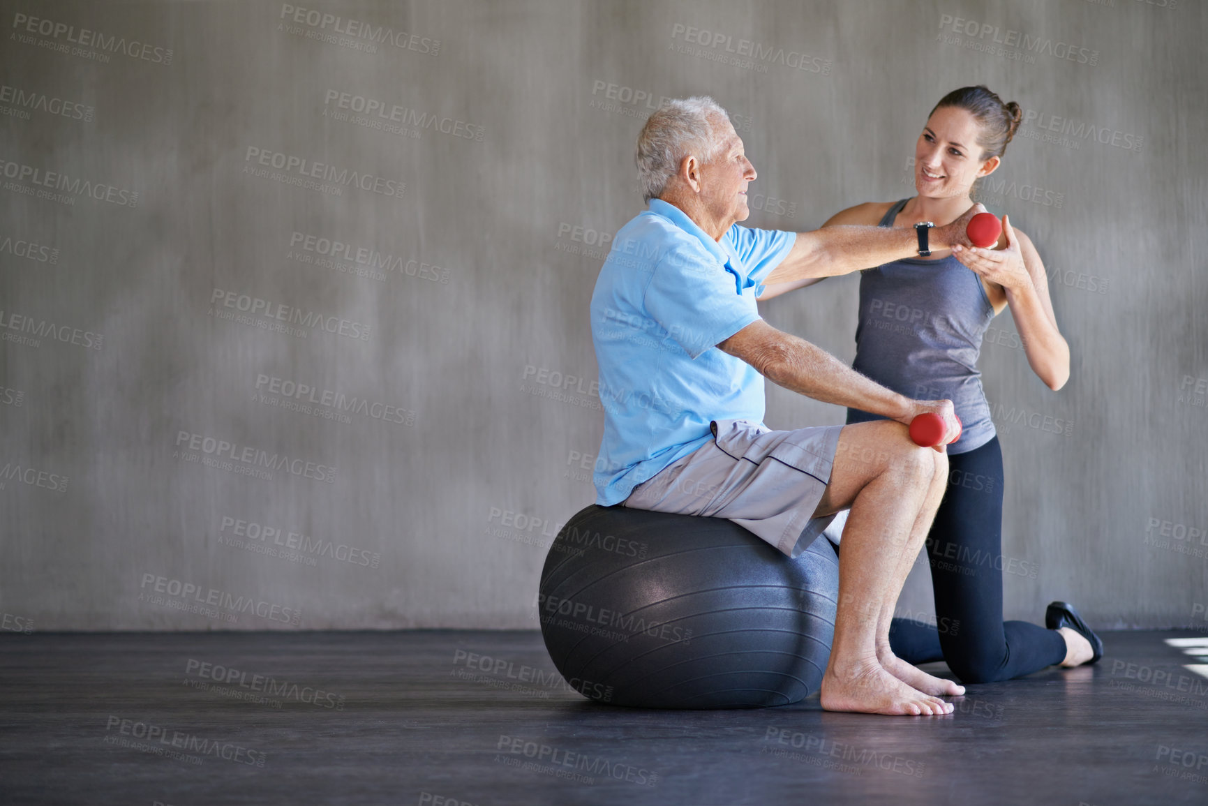 Buy stock photo Shot of a a physical therapist working with a senior man