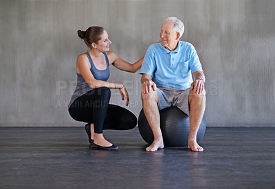 Buy stock photo Shot of a a physical therapist working with a senior man