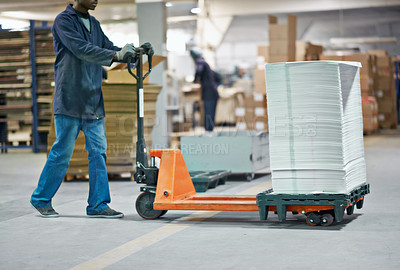 Buy stock photo Man, trolley and distribution with package in supply chain, shipping or delivery at factory or warehouse. Male person. worker or distributor with pile of paper in transport, export or import business