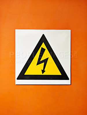 Buy stock photo Warning, sign and voltage with triangle or symbol for alert, precaution or safety at warehouse or factory. Hazard poster or shape in beware of high wattage, electricity or power surge on mockup space