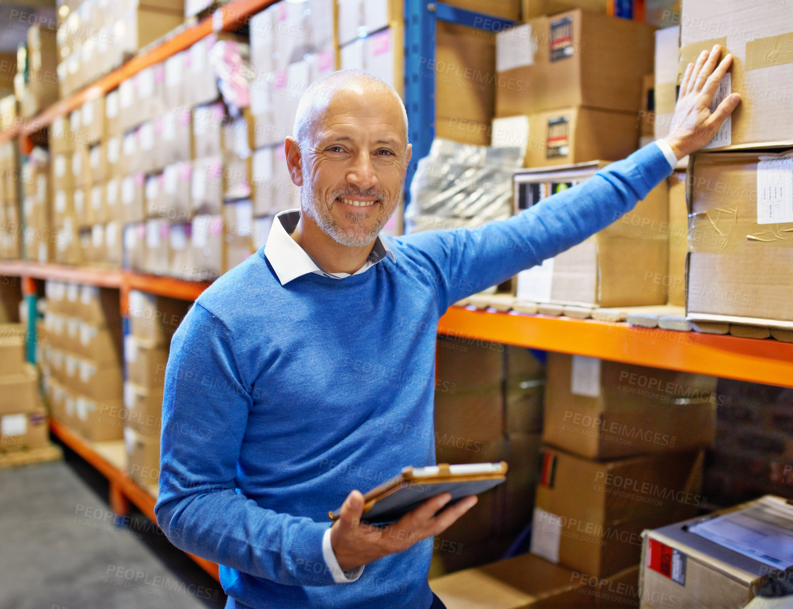 Buy stock photo Portrait of a man standing next to industrial shelving with boxes