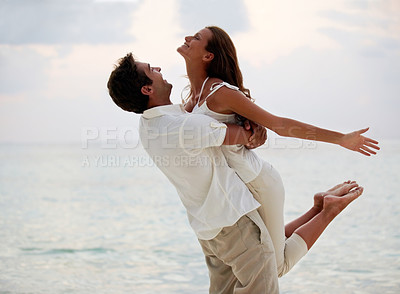 Buy stock photo Couple, celebrate and hug on beach in summer for travel, vacation and holiday in spain together. Man, woman and embrace in paradise by ocean for love, support and romance with freedom and care