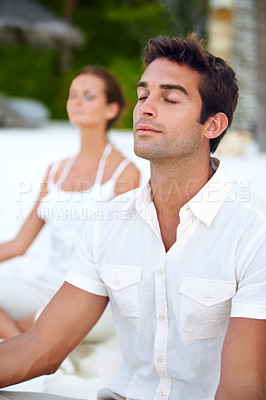 Buy stock photo Yoga, meditation and couple at beach to relax for stress relief, wellness and mindfulness for calm peace. Zen, ocean and people on holiday vacation for spiritual healing, mental health or marriage