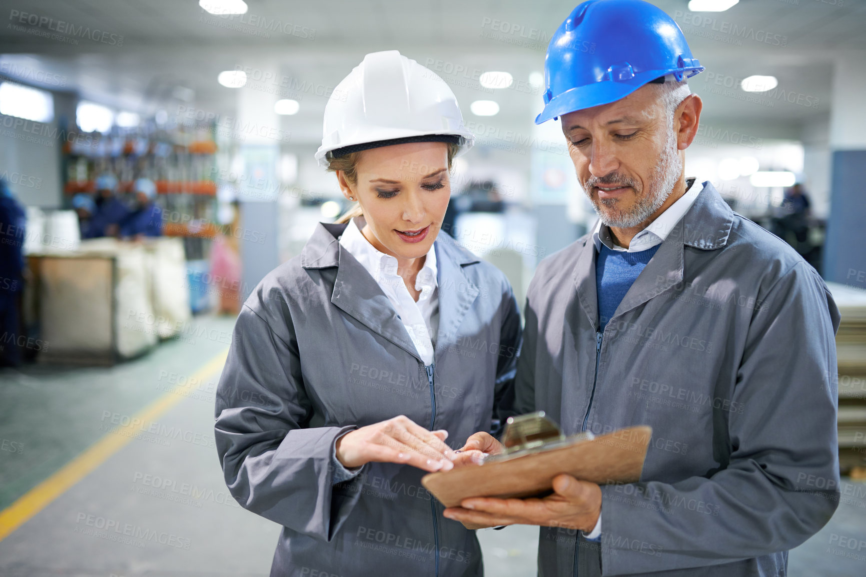 Buy stock photo Man, woman and conversation with clipboard in factory for quality inspection or safety checks and process monitoring. Team, communication and board for manufacturing information in printing warehouse