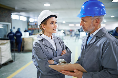 Buy stock photo Man, woman and communication with clipboard in factory for quality inspection or safety checks and process monitoring. Team, conversation and board for manufacturing information in printing warehouse