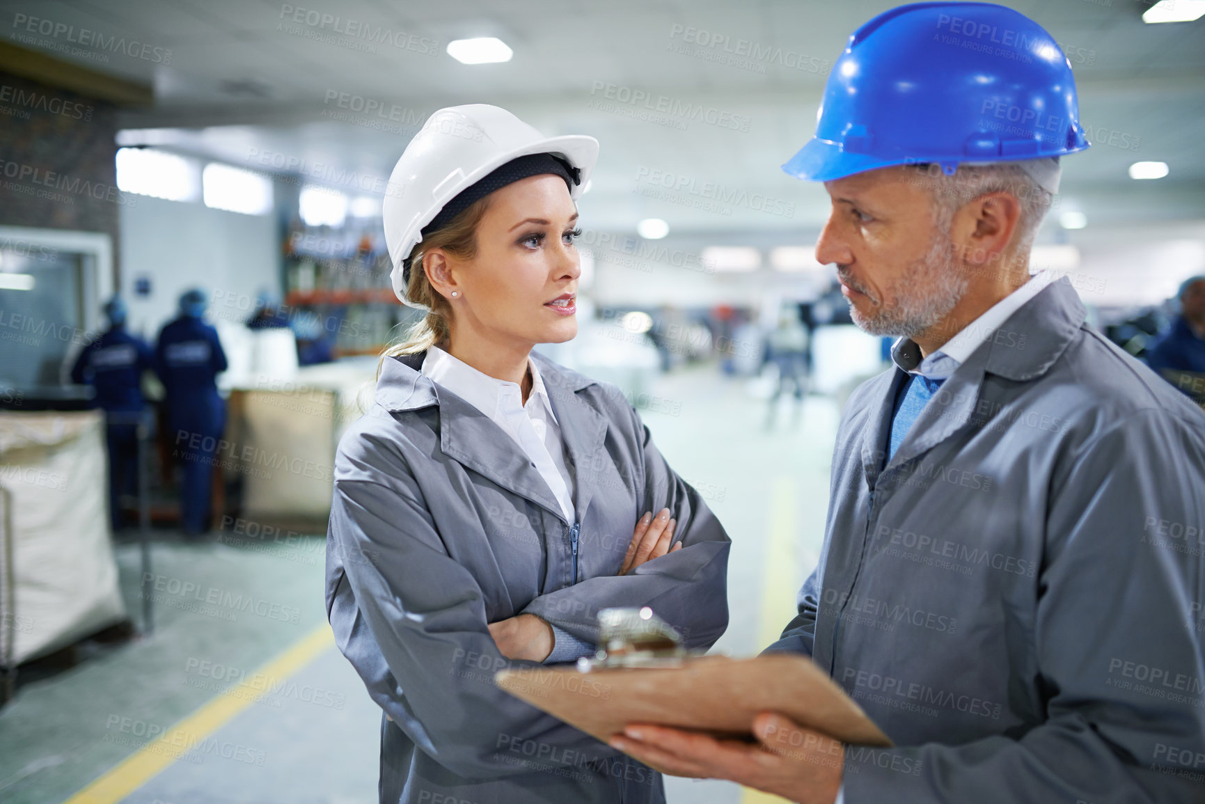 Buy stock photo Man, woman and communication with clipboard in factory for quality inspection or safety checks and process monitoring. Team, conversation and board for manufacturing information in printing warehouse