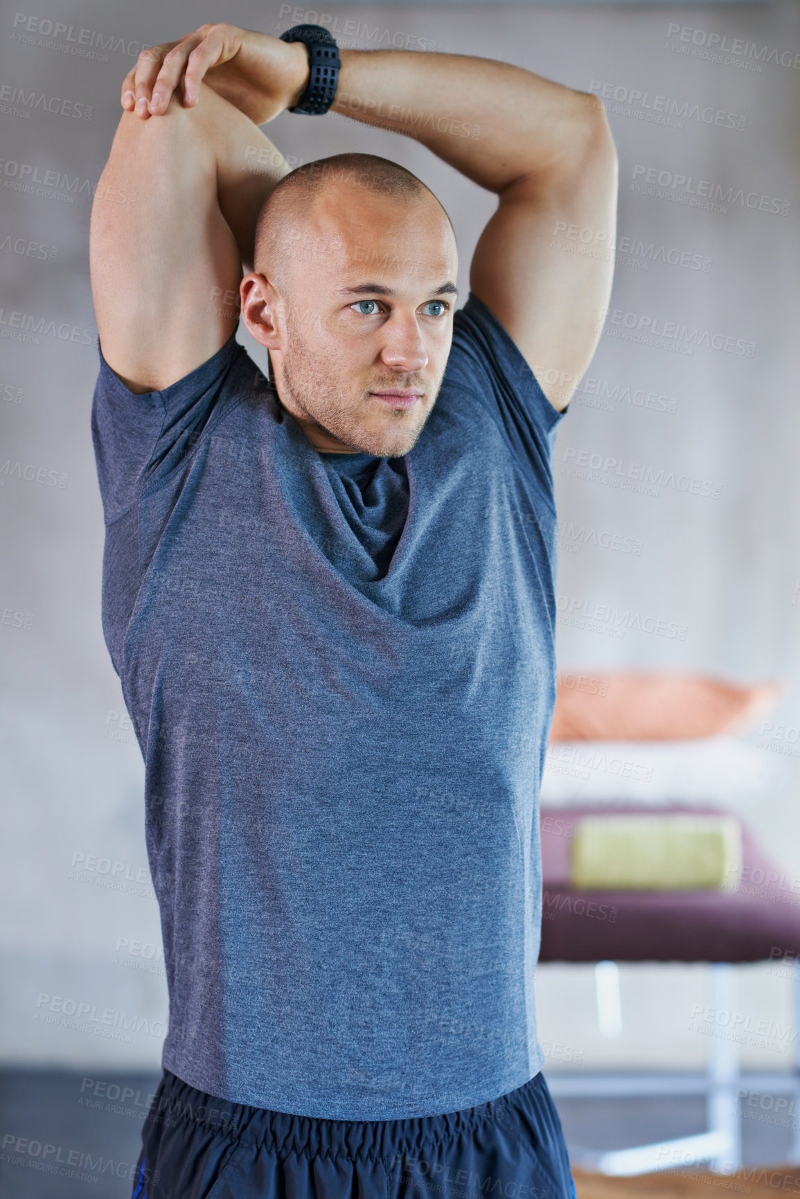 Buy stock photo A cropped shot of a handsome trainer stretching before a workout session