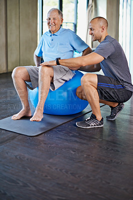 Buy stock photo Physiotherapist, support and senior man with ball, training and elderly help for care. Men, gym and exercise for health, wellness and coaching with osteoporosis for mature rehab and wellbeing