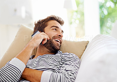 Buy stock photo Man talking on his cellphone at home