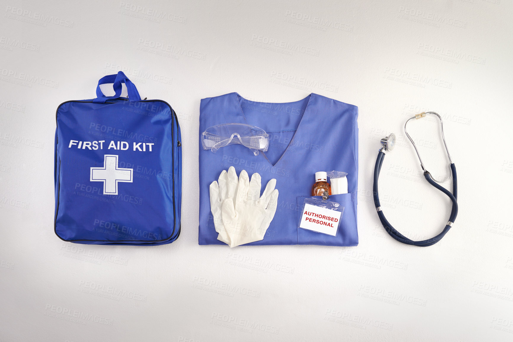 Buy stock photo Medical kit, doctor scrubs and hospital equipment on a table for safety and healthcare in a clinic from above. Flat and top view of a bag, uniform and stethoscope on a desk before a procedure