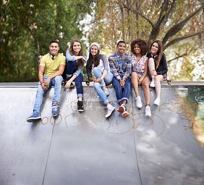 Buy stock photo Portrait, happy and group of teenagers at skatepark in city for bonding, having fun and sitting together. Smile, diversity and young gen z friends in with skateboard in town for practice or training.