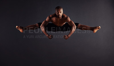 Buy stock photo Male dancer performing the splits in mid-air
