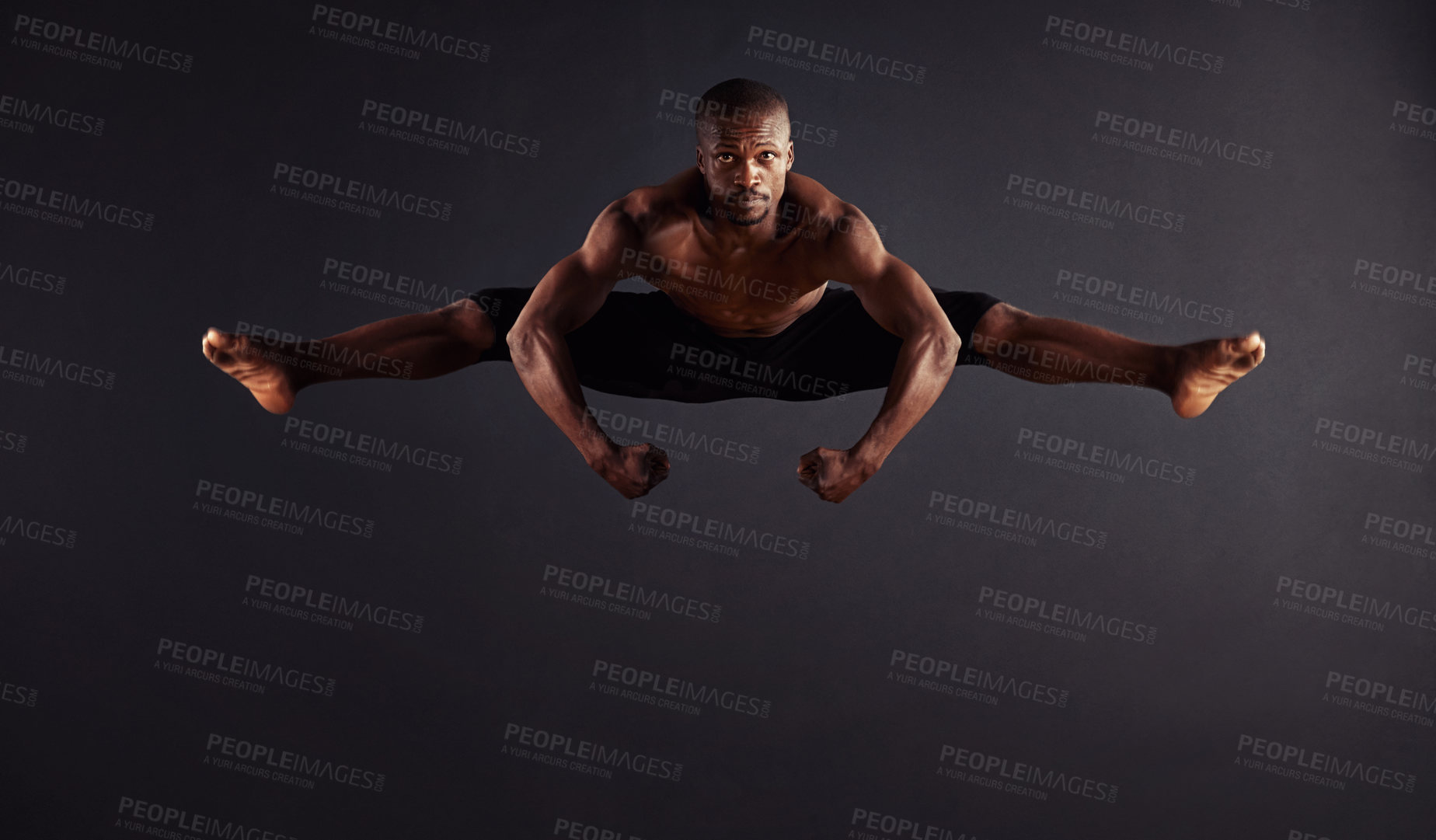 Buy stock photo Male dancer performing the splits in mid-air