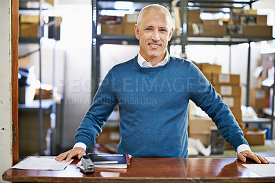 Buy stock photo Man, portrait and logistics in warehouse with smile for manufacturing at counter for supply chain, shipping and management. Male person, factory and boss for commercial distribution of cargo in plant