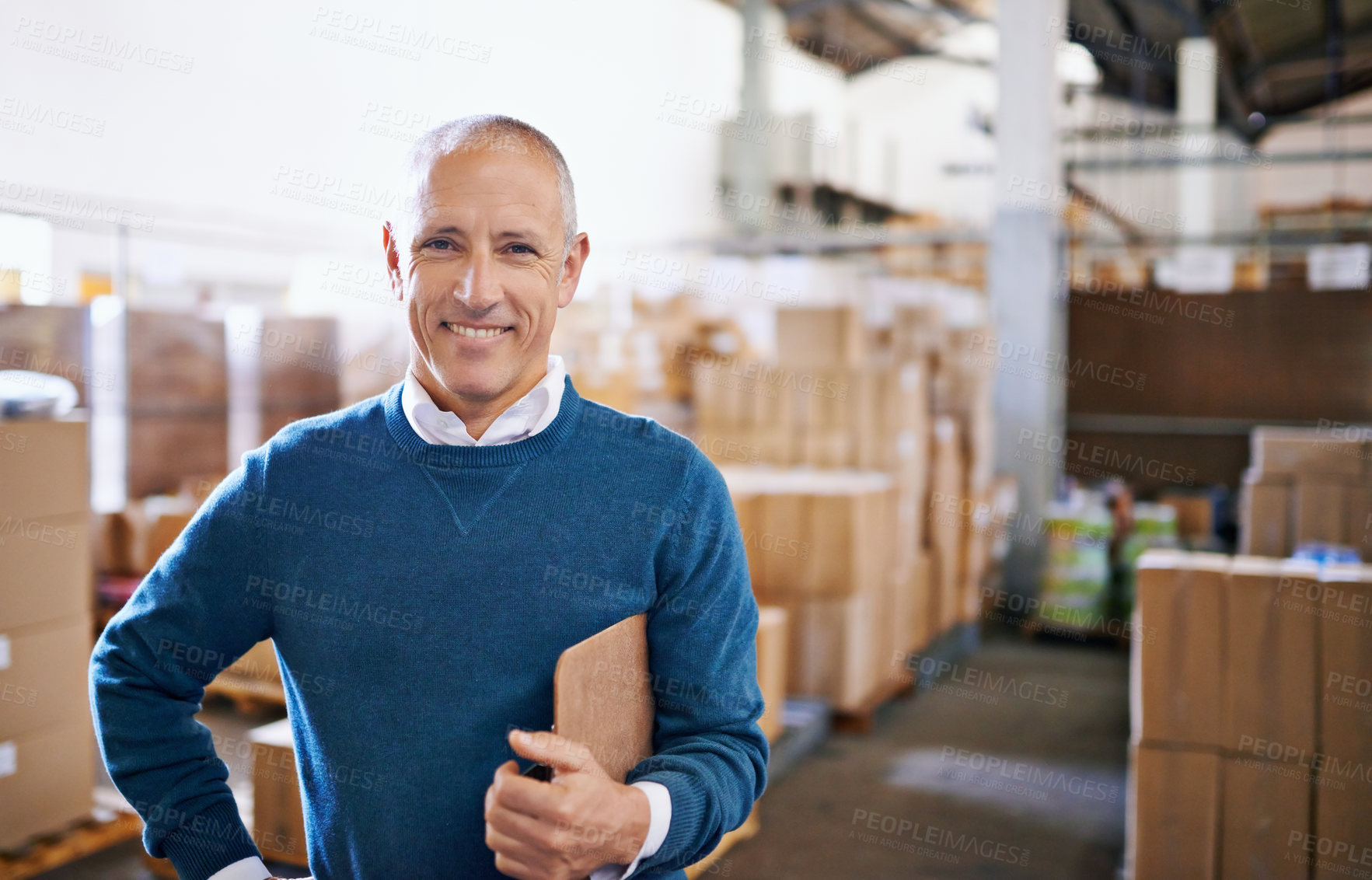 Buy stock photo Portrait of a mature man standing in a distribution warehouse