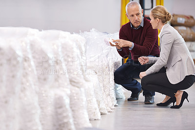 Buy stock photo Shot of two factory managers doing an inspection of raw materials